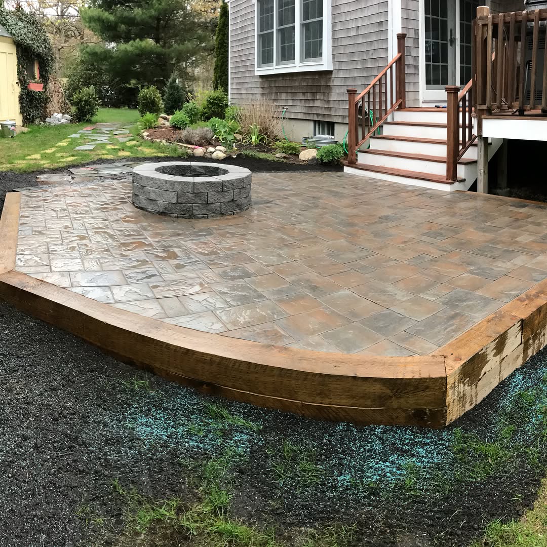 The finished paver patio with fire pit and timber edge