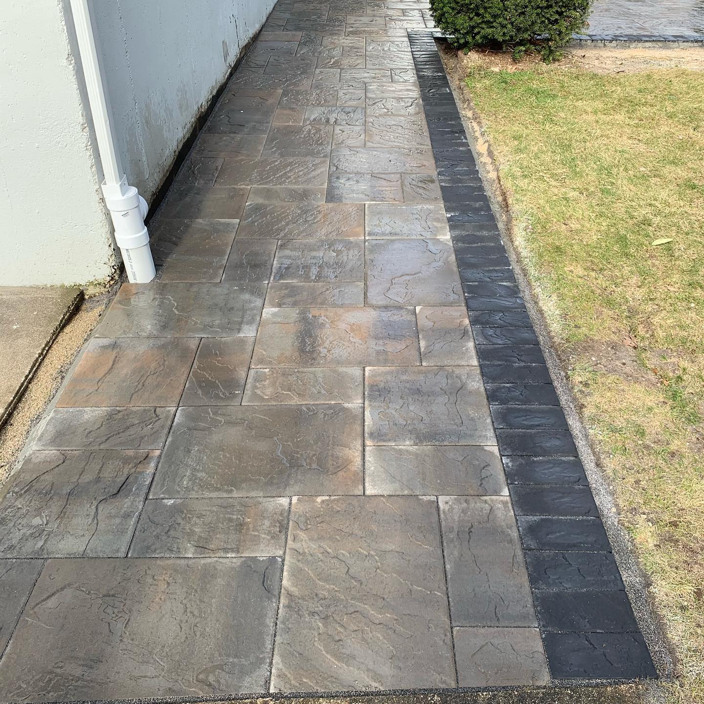 A stone walkway curving through a garden